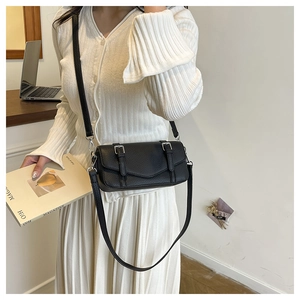 Chic black litchi pattern leather crossbody square bag with silver metal buckles on model
