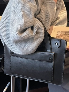 Classic black leather tote bag with front flap pocket for business commute and travel