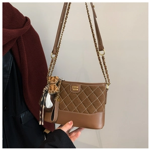 Detail of vintage rhombic pattern shoulder bag with suede leather and metal logo