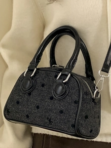 Chic black bow pattern bowling bag with silver hardware shown on a model