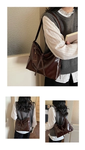 Detailed view of large dark brown tote bag with glossy oil wax leather texture and side drawstrings