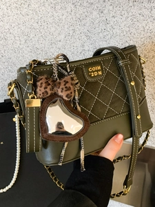 Dark green quilted hobo bag with gold chain strap and leopard heart mirror charm
