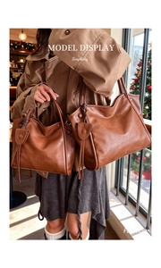 Detailed comparison of two caramel brown leather tote bags in medium and large sizes