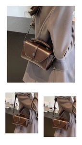 Detail view of deep brown vintage crossbody bag styled with a brown office suit