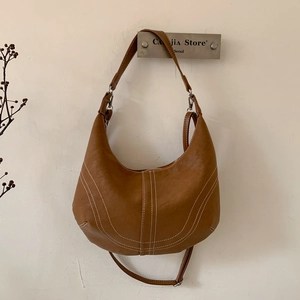 Vintage brown hobo shoulder bag with white contrast stitching for a retro look