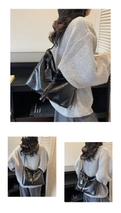 Detail of black wax leather tote bag with metallic buckle and vintage square logo charm