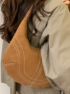 Vintage brown leather hobo bag with contrast stitching in a half-moon shoulder style