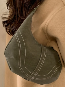 Vintage olive green large hobo shoulder bag with contrast stitching on wool coat