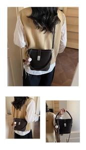 Close-up of dark brown leather bucket bag with silver twist lock and horse charm