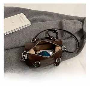 Interior view of brown leather Boston bag showing spacious storage for makeup and phone