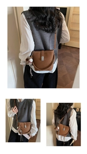 Detailed view of brown retro bucket bag with adjustable straps and horse plush charm