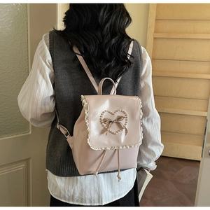 Detailed back view of pink mini backpack with lace trim and heart pearl bow detail