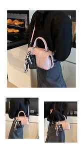 Pink metallic bowling bag with embossed logo and decorative accessories in a kitchen scene