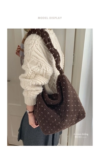 Detail view of brown fleece hobo tote bag showing soft texture and white polka dot pattern