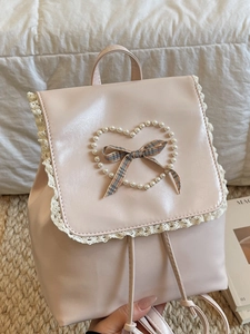 Sac à dos en similicuir rose avec bordure en dentelle, cœur perlé et nœud à carreaux