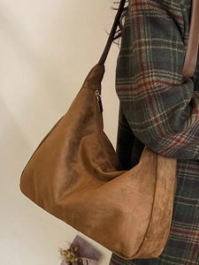 Brown suede large capacity tote bag styled with a plaid wool coat for winter commute