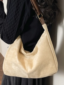 Large beige suede hobo tote bag with brown leather strap for elegant winter commuting
