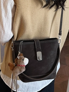 Retro dark brown matte bucket bag with silver metal clasp and cute plush horse pendant