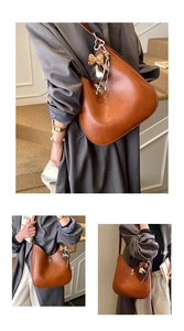 Detail view of caramel brown large capacity shoulder bag with leopard bow and heart charm