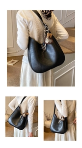 Detail of black Hobo bag featuring silver lock and leopard print heart charm
