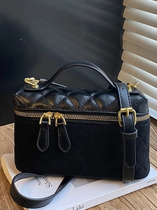Black quilted leather vanity shoulder bag with gold zipper and adjustable strap
