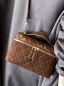 Brown quilted crossbody bag in faux suede and leather featuring dual gold zippers