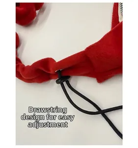 Detail of red plush bag with black adjustable drawstring and plastic toggle buckle