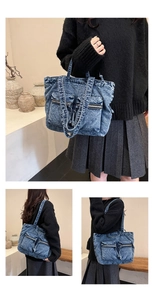Detail view of retro acid wash blue denim tote bag with dual front zipper pockets