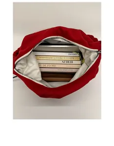 Macro view of spacious red tote interior with light grey lining and silver metal zipper