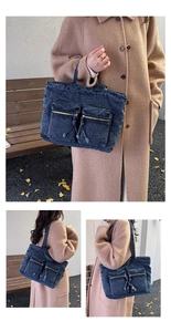 Detail view of washed denim tote bag with cargo pockets and fringe trim for daily use