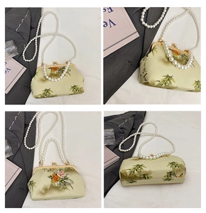 Detail of silk chain bag with traditional flower bamboo patterns and pearl handle