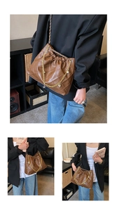 Detail of coffee brown quilted shoulder bag with gold chain and heart charms