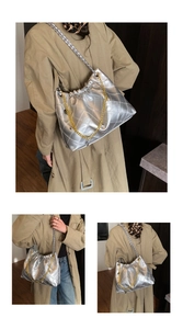 Detail of silver quilted tote bag with metallic finish and gold decorative chain