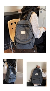 Close-up of checkered backpack featuring a branded woven label and side utility pockets