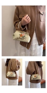 Detailed embroidery and pearl strap texture on the oriental vintage kiss-lock purse