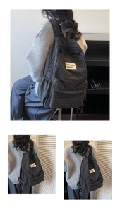 Close-up of minimalist dark gray checkered nylon backpack with side pockets and detail