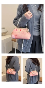 Detail view of pink oriental style bag with floral bird print and pearl chain strap