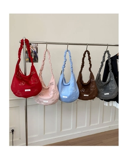 Close-up of five colorful knit tote bags with floral prints and scrunchie handles