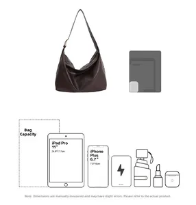 Detail view of large brown hobo bag showing capacity for 11 inch tablet and daily essentials
