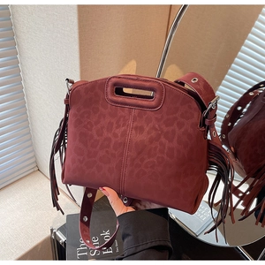 Détail du sac à main bordeaux à motif léopard avec franges et large bandoulière réglable