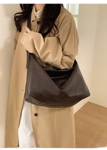Side view of dark brown leather hobo bag showing stylish drape and large capacity