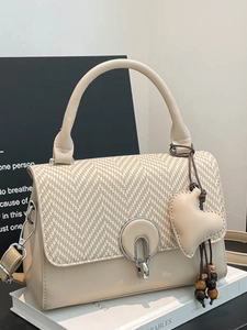 Elegant beige herringbone woven crossbody bag with heart pendant and metal circular lock