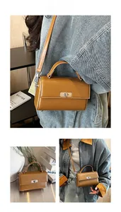Detail view of the warm brown leather handbag with silver metallic twist lock and handle