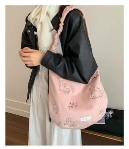 Pink canvas tote bag with bird embroidery and cloud-like ruffled shoulder strap