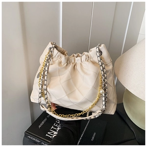 Detail of off-white quilted shoulder bag with mixed metal chain and pearl accent