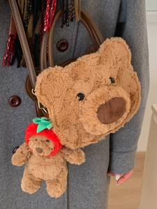 Cute brown plush bear head handbag with leather handles and a small strawberry bear charm