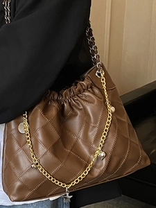 Brown quilted crossbody bag with golden chain strap and decorative star charms