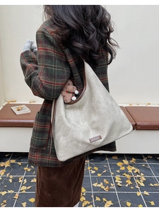 Detail of minimalist cream tote bag with vintage matte texture and brown leather edges