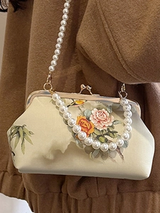 Elegant vintage embroidered satin handbag with pearl handle and traditional floral patterns