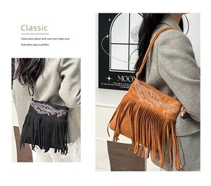 Detail of bohemian fringed shoulder bags with feather embroidery in black and brown